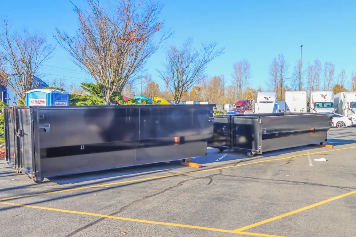 Professional dumpster rental service with roll-off container on residential driveway in Lake San Marcos